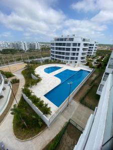 a large apartment building with a large swimming pool at Golden Breeze in Cartagena de Indias