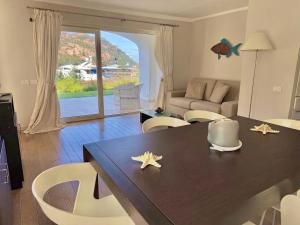a living room with a dining room table with stars on it at Poltu Quatu House in Porto Cervo