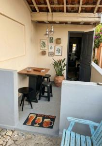 a patio with a wooden table and a table and chairs at Casinha beira praia Gaivota ,há 2 minutos da praia in Itanhaém +16 photos
