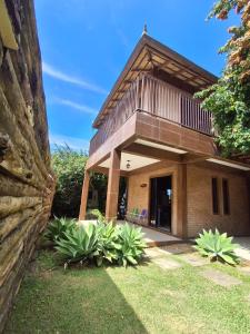 a house with a balcony on top of it at Morada das Flores in Palhoça +16 photos