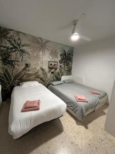 a bedroom with two beds with towels on them at EL PARQUE II - Parking gratuito cercano in Ciudad Real