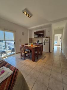 a kitchen and living room with a table and chairs at Departamento confortable con muy buena ubicacion y cochera para 4 personas in Corrientes