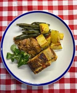 a plate of food with meat and vegetables on a table at Casa Pulverun in Domodossola +4 photos