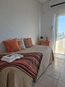 a bedroom with a large bed with an open window at Departamento confortable con muy buena ubicacion y cochera para 4 personas in Corrientes