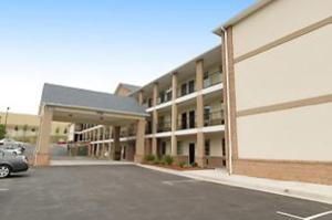 an empty parking lot in front of a building at Garden Inn Hotel in Union City