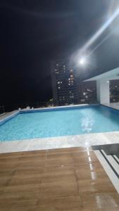 a swimming pool on top of a building at night at Flat Olinda 4 Rodas in Olinda