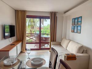 a living room with a couch and a table at Kariri beach apt 427 Praia do Cumbuco in Cumbuco