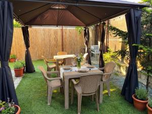 a table and chairs under a gazebo at Serenity Apartments and Studios in Eforie Nord