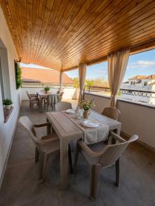 a dining room with a table and chairs on a balcony at Serenity Apartments and Studios in Eforie Nord