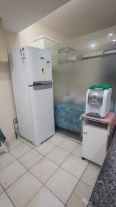a kitchen with a white refrigerator and a printer at Flat Olinda 4 Rodas in Olinda
