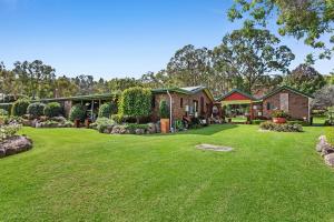 a house with a large yard in front of it at 31 The Rocks in Stanthorpe