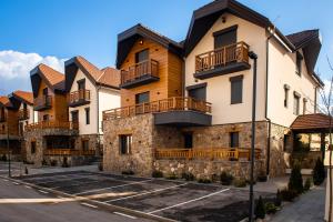 a row of houses with balconies on a street at Apartment Vila Jela in Kolašin