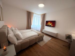 a white bedroom with a bed and a window at Apartmán SteMa Home in Františkovy Lázně