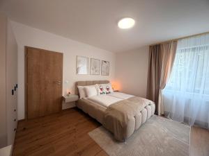 a bedroom with a bed and a large window at Apartmán SteMa Home in Františkovy Lázně