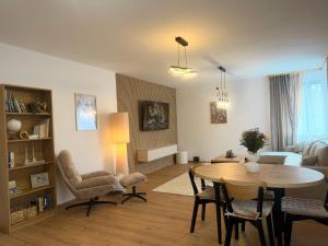 a living room with a table and chairs and a couch at Apartmán SteMa Home in Františkovy Lázně
