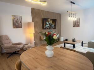 a living room with a vase of flowers on a table at Apartmán SteMa Home in Františkovy Lázně