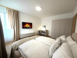 a bedroom with a bed with a fireplace on the wall at Apartmán SteMa Home in Františkovy Lázně +19 photos