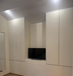 a white cabinet with a tv in it at La Casa di Vale in Ventimiglia