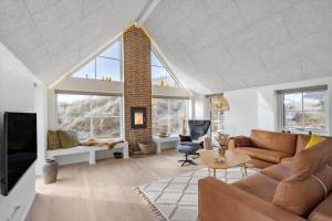 a living room with a couch and a fireplace at 1159-Ringkobing-Anders-Juhls-Vej-13 in Søndervig