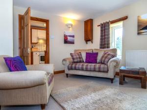 a living room with two chairs and a couch at Yr Hen Felin in Mathry