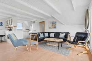 a living room with a couch and chairs and a table at 2250-Ringkobing-Vestklitvej-25 in Klegod +24 photos