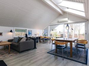 a living room with a couch and a table at Cozy Retreat by Koge Bay - By Traum Ferienwohnungen in Strøby +20 photos