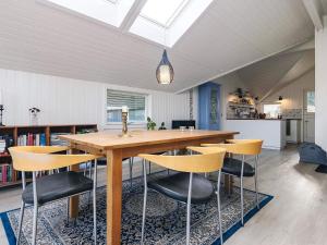 a dining room with a wooden table and chairs at Cozy Retreat by Koge Bay - By Traum Ferienwohnungen in Strøby