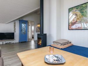 a living room with a table and a fireplace at Cozy Retreat by Koge Bay - By Traum Ferienwohnungen in Strøby