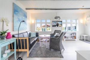 a living room with a couch and a table at 085-Ringkobing-Nordsovej-68 in Søndervig