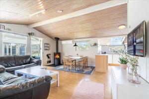 a living room with a couch and a table at 156-Ringkobing-Birkealle-14 in Nørby