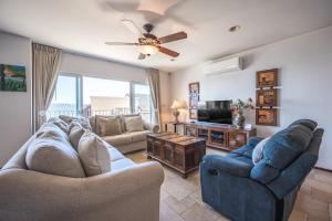a living room with two couches and a tv at Corona del Mar #6 in Ocotal