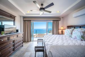 a bedroom with a bed and a television and a balcony at Corona del Mar #6 in Ocotal +21 photos