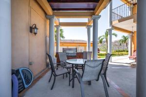 a patio with a table and chairs on a porch at Corona del Mar #6 in Ocotal