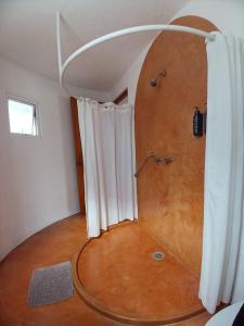 a bathroom with a shower with a wooden floor at Hacienda Panoaya in Amecameca de Juárez +46 photos