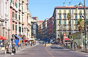 a city street with buildings and people walking down the street at Hely's House in Naples