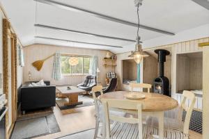 a kitchen and living room with a table and chairs at 160-Ringkobing-Granalle-17 in Nørby