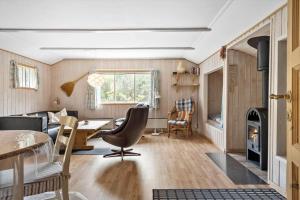 a living room with a couch and a table at 160-Ringkobing-Granalle-17 in Nørby