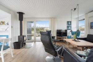 a living room with a couch and a table at 208-Ringkobing-Fladsbjergvej-226 in Klegod