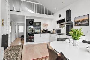 a kitchen and dining room with a table and chairs at 1130-Ringkobing-Sletten-18 in Søndervig