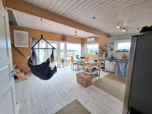 a living room with a hammock hanging from the ceiling at Newly-built villa in a perfect location! in Grebbestad +8 photos