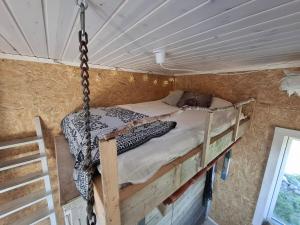 a bed in a swinging bed in a room at Newly-built villa in a perfect location! in Grebbestad