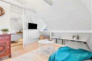 a white room with a bed and a table at 1154-Ringkobing-Nordsovej-50 in Søndervig
