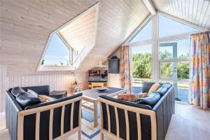 a living room with a couch and a table at 221-Ringkobing-Havklitvej-72 in Klegod