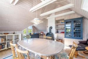 a kitchen and dining room with a table and chairs at 221-Ringkobing-Havklitvej-72 in Klegod