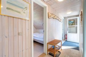 a small room with a bedroom and a bed at 221-Ringkobing-Havklitvej-72 in Klegod