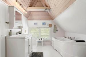 a white bathroom with a sink and a toilet at 123-Ringkobing-Granalle-3 in Nørby +31 photos