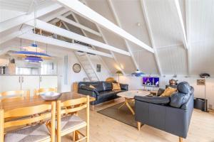 a living room with a table and a dining room at 207-Ringkobing-Nordso-Ferievej-27 in Nørre Lyngvig