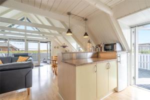 a kitchen and living room with a couch and a counter at 207-Ringkobing-Nordso-Ferievej-27 in Nørre Lyngvig