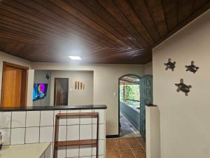 a kitchen with a wooden ceiling at Green Area House in Abraão
