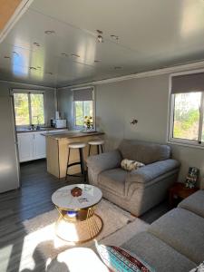 a living room with a couch and a table at Centrally located peaceful place in Greymouth